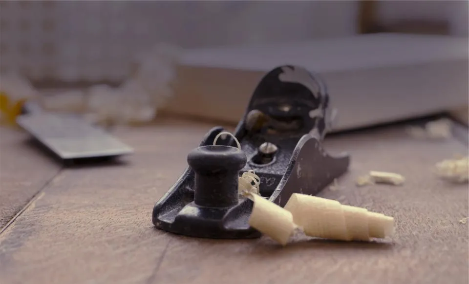 Hand plane and wood shavings on a workbench