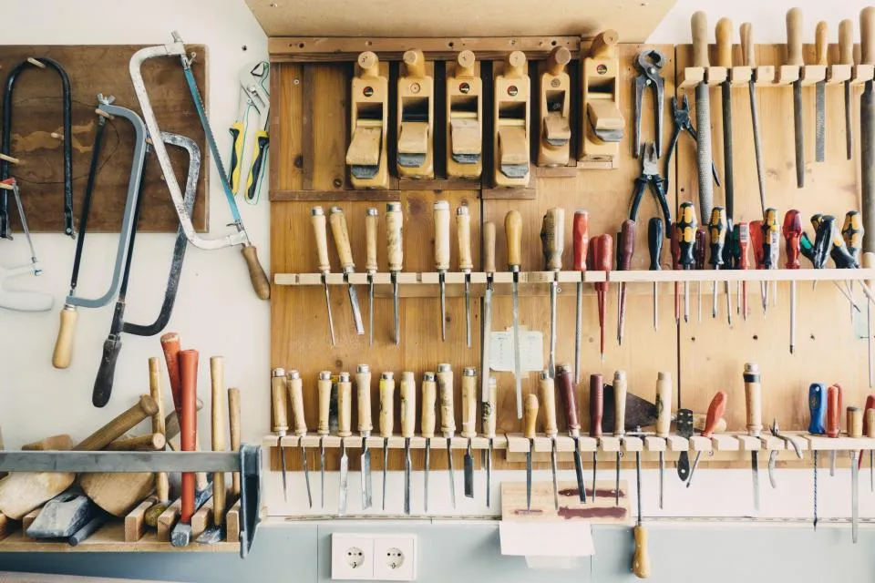Wall of hand tools hanging in a workshop